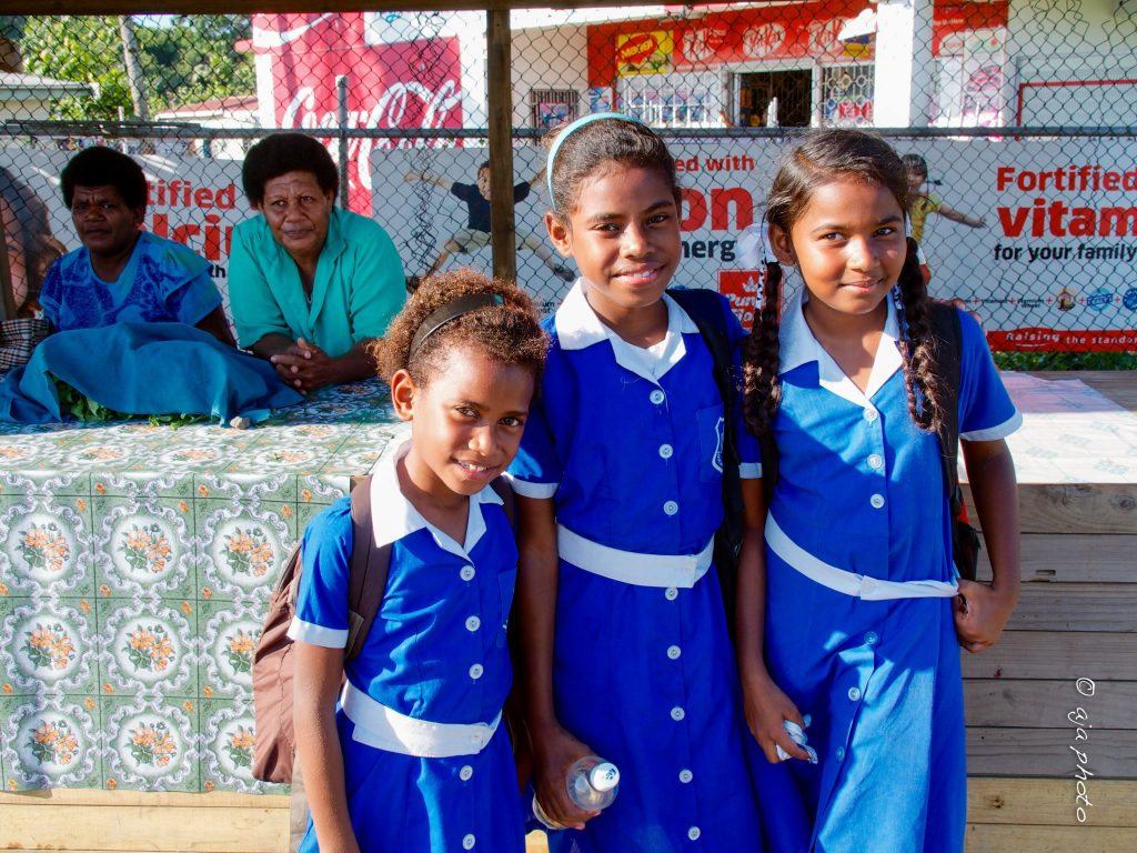 Three school children heading to school Three school children heading to school -- education is a valued component of Fiji culture